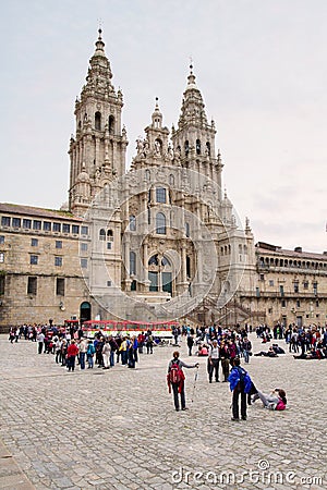 Santiago de Compostela cathedral facade . View from obradoiro square with groups of pilgrims and tourists Editorial Stock Photo