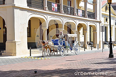 Santo Domingo, Dominican Republic. Man driving a horse-drawn carriage in the Colonial Zone near the Columbus Park Editorial Stock Photo