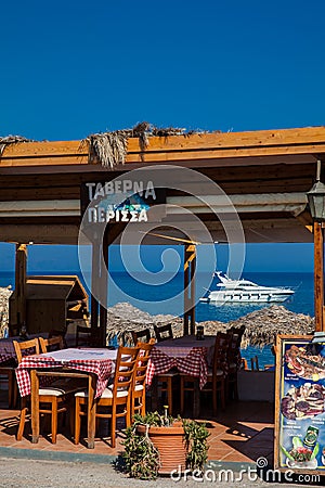 Waterfront restaurants at the beautiful Perissa beach in Santorini Island Editorial Stock Photo