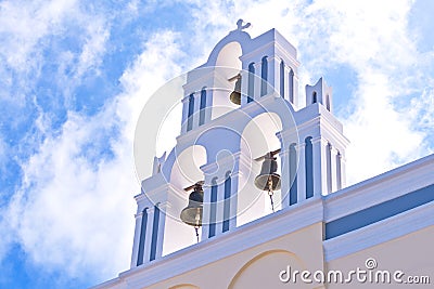 Santorini Greece Church with bells and cross against blue sky Stock Photo