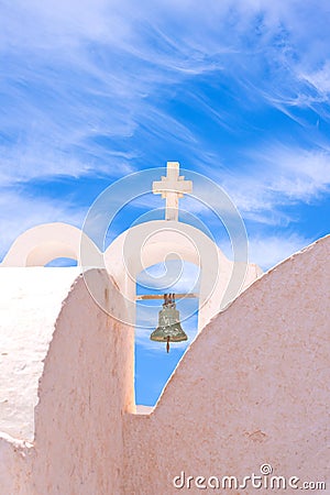 Santorini Greece Church with bells and cross against blue sky Stock Photo