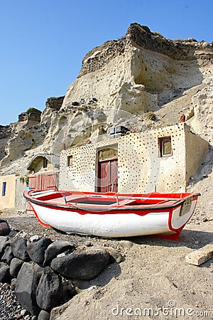 Santorini, Greece: a fisherman boat under the volcanic cliffs Stock Photo