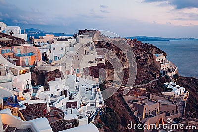 Santorini island Oia sunset landscape. Traditional white houses and castle ruins with sea view. Travel to Greece Stock Photo