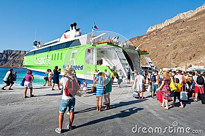SANTORINI-JULY 28: Tourists board on the ferry on July 28, 2014 on the port of Thira. Santorini, Greece. Editorial Stock Photo