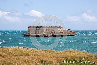 Sao Lourenco Blockhouse. San Lorenzo Island, fort nearby grassy shore and coastline of Mozambique island, Indian ocean coast. Stock Photo