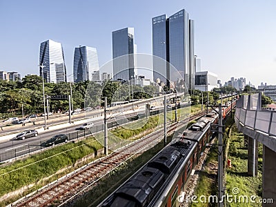 View of buildings, CPTM train, traffic of vehicles and river in Marginal Pinheiros River Avenue Editorial Stock Photo