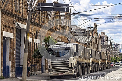 Trucks parked in front of old warehouses Editorial Stock Photo