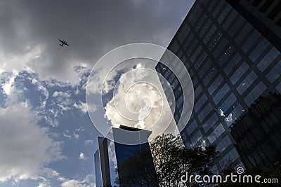 Business airliner flies over the roof of office building in Faria Lima Avenue, west side of Sao Paulo city Editorial Stock Photo