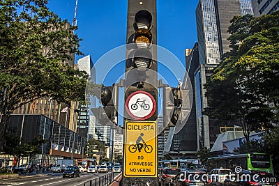 Semaphore and bicycle path in Paulista Avenue. on the sign `cyclist, only dares in the green` in Portuguese Editorial Stock Photo