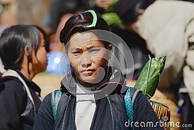 Portrait of an Black Miao Hmong minority woman wearing traditional costume at the street in Sapa, Vietman. Editorial Stock Photo