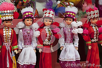 Dolls girls in red national clothes Red dzao - a small nation of North Vietnam Editorial Stock Photo