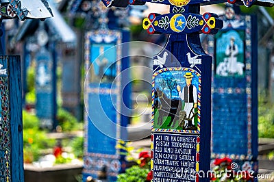 Sapanta, Maramures, Romania - June 17, 2022: Painted blue wooden monuments in an unique in the World Editorial Stock Photo