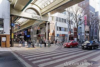Sapporo cityscape with buildings, road, cars and walking people in Hokkaido, Japan Editorial Stock Photo