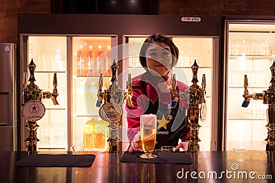 SAPPORO, Japan - MAY 05, 2016: a waitress serve a beer in Sapporo beer musuem in Sapporo, Hokkaido, Japan Editorial Stock Photo