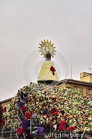 Saragossa, Spain - October 12, 2017: Volunteers placing flowers on the day of the flower offering to the Virgen del Pilar in Editorial Stock Photo