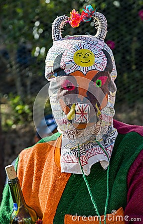 Saraguro, Ecuador - December 23, 2017 - Man wears traditional devil mask at outdoor fair Editorial Stock Photo