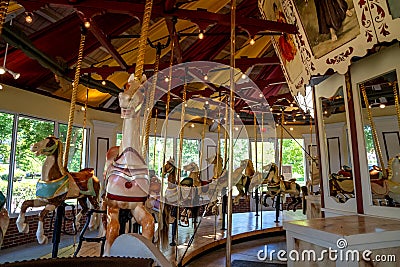 A horizontal interior view of the Congress Park Carousel. It features 28 horses and Editorial Stock Photo
