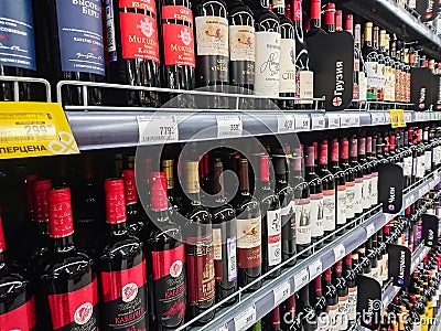 Various brands of red and pink wine on the shelves of the supermarket. Editorial Stock Photo