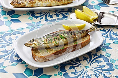 Portuguese grilled sardine on toasted bread Stock Photo