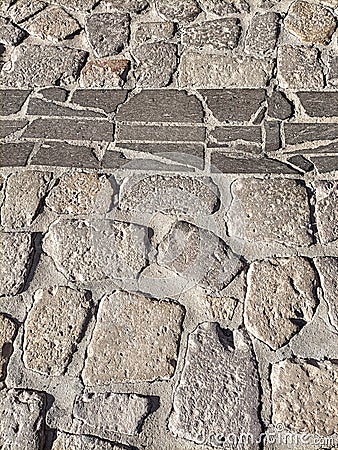 Sardinia. Traditional architecture. Urban road paved with rough ashlars and polished slabs of local volcanic stones. Detail Stock Photo