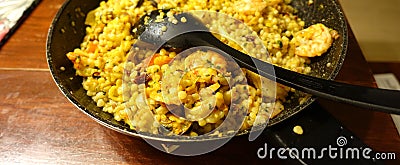 Sardinian fregula, traditional Sardinian pasta, made in a pan with seafood and saffron. Stock Photo