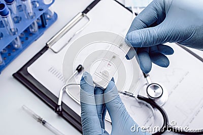 Sars test antigen coronavirus kit. Doctor holding rapid covid medical test. Laboratory hospital lab background. Patient Stock Photo