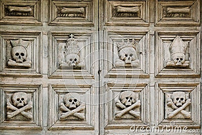 Sassi di Matera. The old door to the church is decorated with crossbone skulls Stock Photo