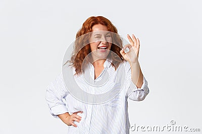 Sassy good-looking middle-aged redhead woman assure everything okay, guarantee or recommend something, approve plan Stock Photo