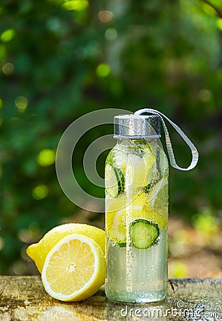 Sassy water. Detox water with lemon. Bottle of cold water with lemon Stock Photo