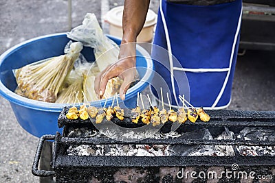 Traveling satay vendor grilled satay at night market. Stock Photo