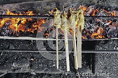 Sate Lilit Bali or wrapped sate is Traditional Balinese minced seafood satay is grilled on charcoal Stock Photo