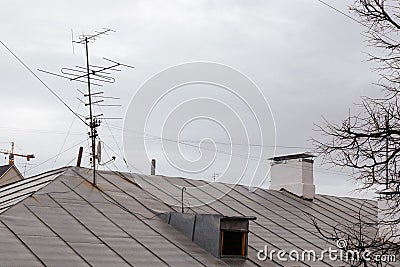 Satellite antenna and old roof antenna on a red roof Stock Photo