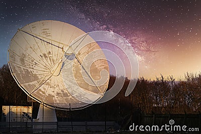 Satellite dish large and antenna for communication and mobile technology network at night starry sky showing the galaxy stars Stock Photo