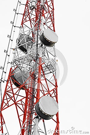 Satellite dish telecoms on telecommunications tower on white clear sky Stock Photo