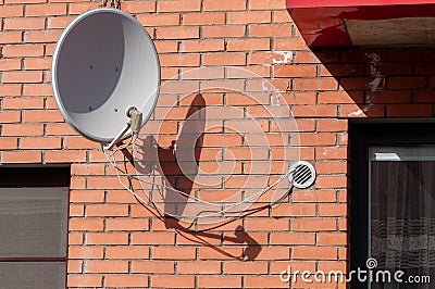 Satellite dish on the wall Stock Photo