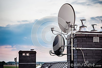 Satellite dishes, satellite antennas mounted on the chimney Stock Photo