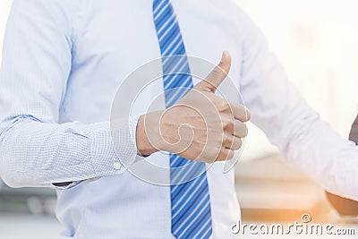 Satisfaction happy businessman showing thumbs up for good work. Positive idea hand of business people. Thumbs up good sign in Stock Photo