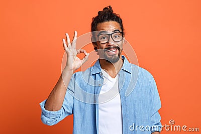 Satisfied african american man showing okay gesture with hand, demonstrating approvement Stock Photo