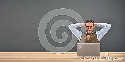 Satisfied businessman relaxing in front of laptop Stock Photo