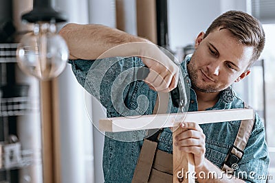 Satisfied carpenter tightening screws Stock Photo