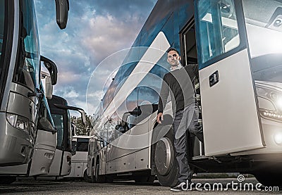 Satisfied Caucasian Bus Driver Leaving Coach After Hard Day on the Road Stock Photo