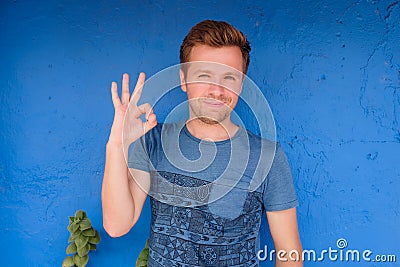 Satisfied caucasian young man showing okay sign Stock Photo