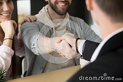 Satisfied couple handshaking realtor closing successful deal Stock Photo