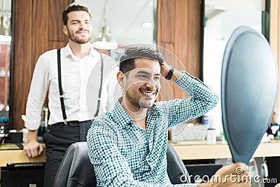 Satisfied Customer Looking At Mirror After The Hairstyling At Sh Stock Photo