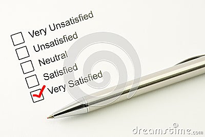 Satisfied customer service feed back. Consumer satisfaction concept. Marked checkbox with a pen on paper background Stock Photo