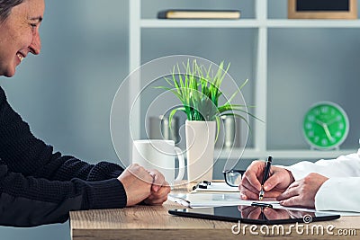 Satisfied happy female patient in hospital office after medical Stock Photo