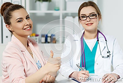 Satisfied happy female patient with medicine doctor at her office Stock Photo