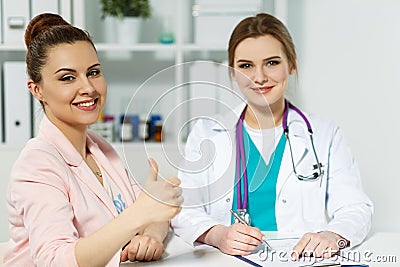 Satisfied happy female patient with medicine doctor at her office Stock Photo