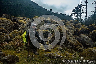 A satisfied happy trekker is enjoying the sun rise with walking stick Editorial Stock Photo