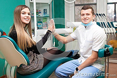 Satisfied patient gives five to the dentist after treatment Stock Photo